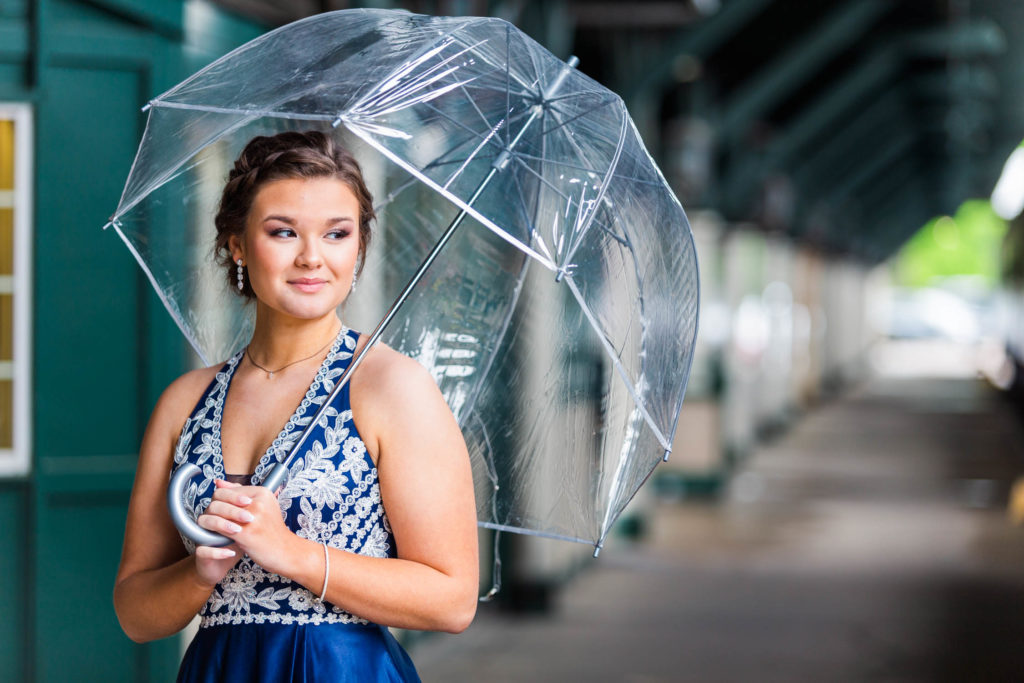 Girl taking photos with pretty umbrella before prom in Chattanooga, Tennessee at the Choo Choo