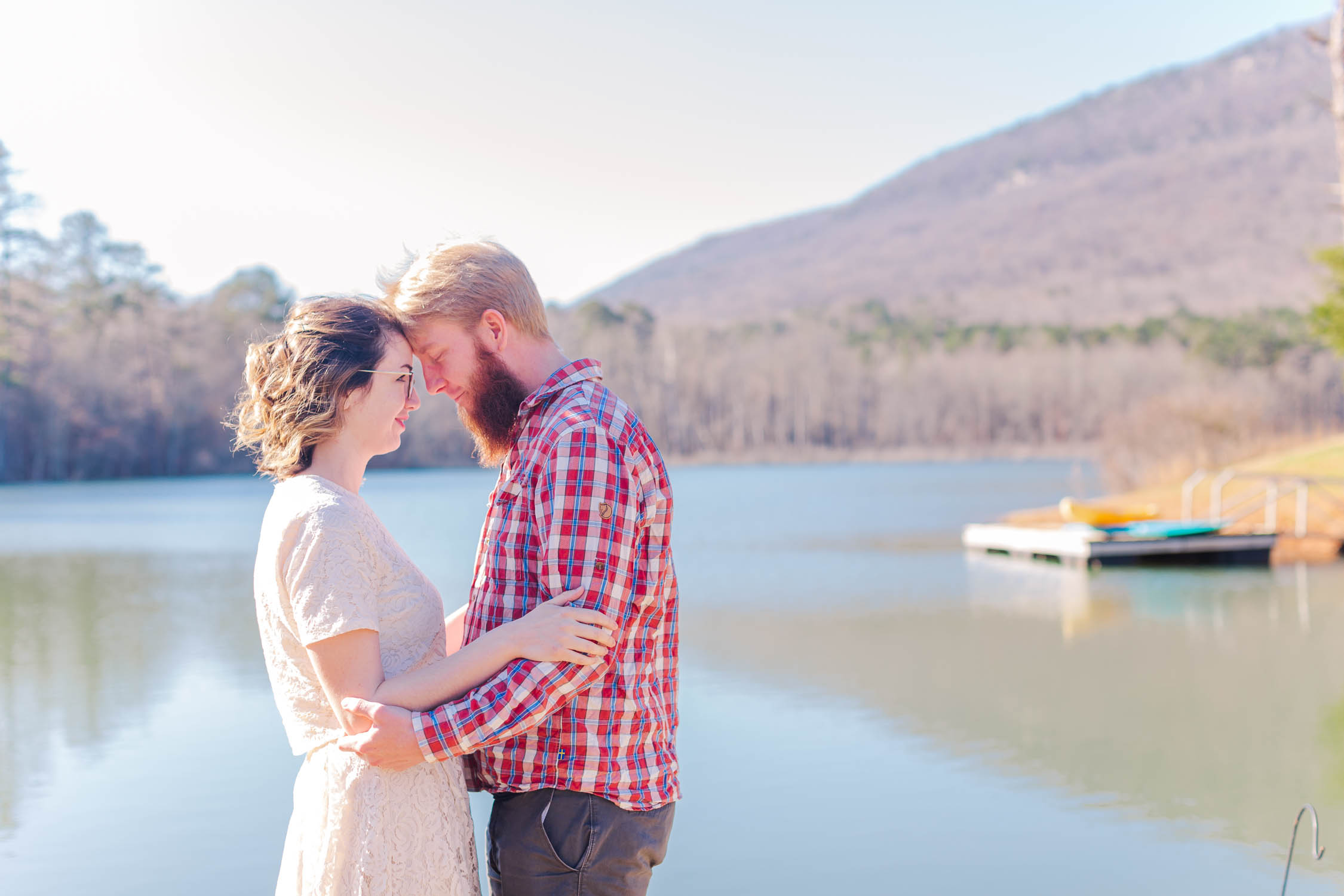 Couple poses in front of beautiful mountain view for anniversary session at Pigeon Mountain Crossing in LaFayette, Georgia