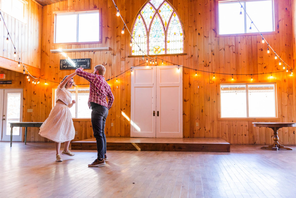 Couple spins during a dance in the barn ballroom at Pigeon Mountain Crossing