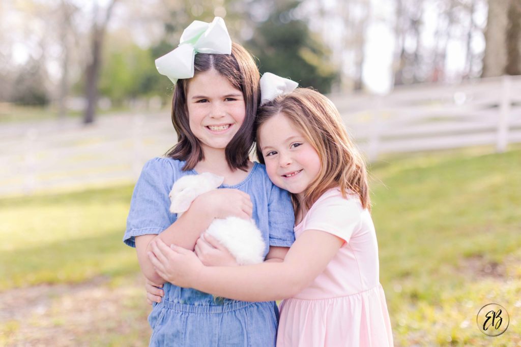 Girls cuddle bunny at live bunny mini sessions