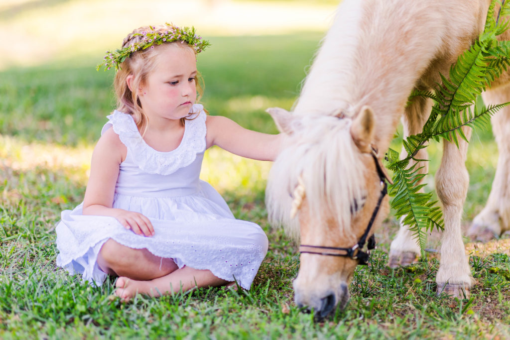 Little girl sits with Wesley the unicorn in a photo by Elle Bea Photography in Chickamauga, Georgia near Chattanooga, Tennessee