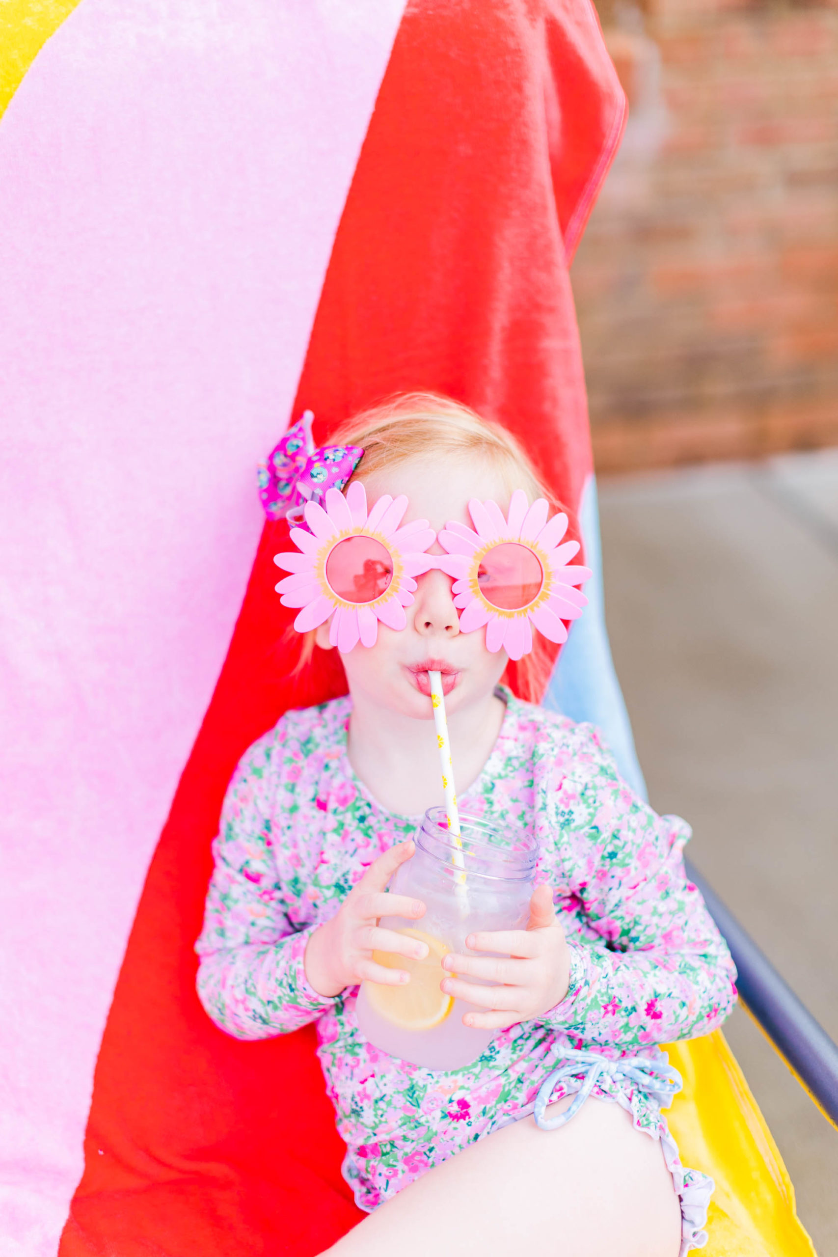 Happy girl drinks lemonade at Pool Party Mini Sessions in Rossville, Georgia by local photographer Elle Bea Photography