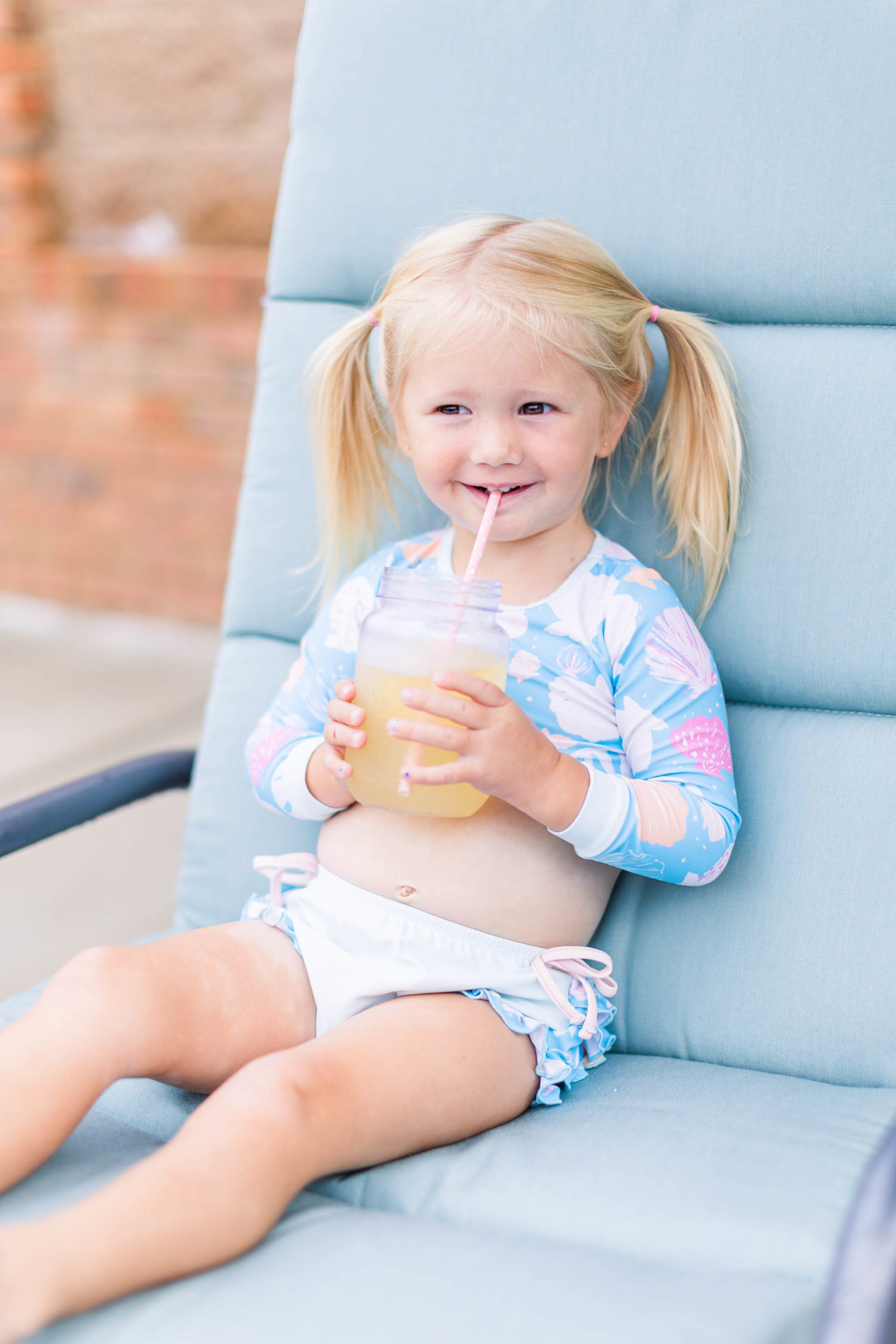 Happy girl drinks lemonade at Pool Party Mini Sessions in Rossville, Georgia by local photographer Elle Bea Photography