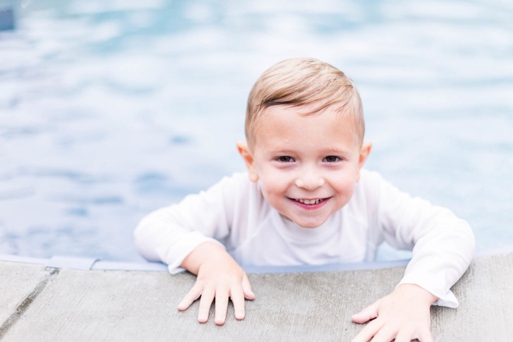 Happy boy swims and smiles at Pool Party Mini Sessions in Rossville, Georgia by local photographer Elle Bea Photography