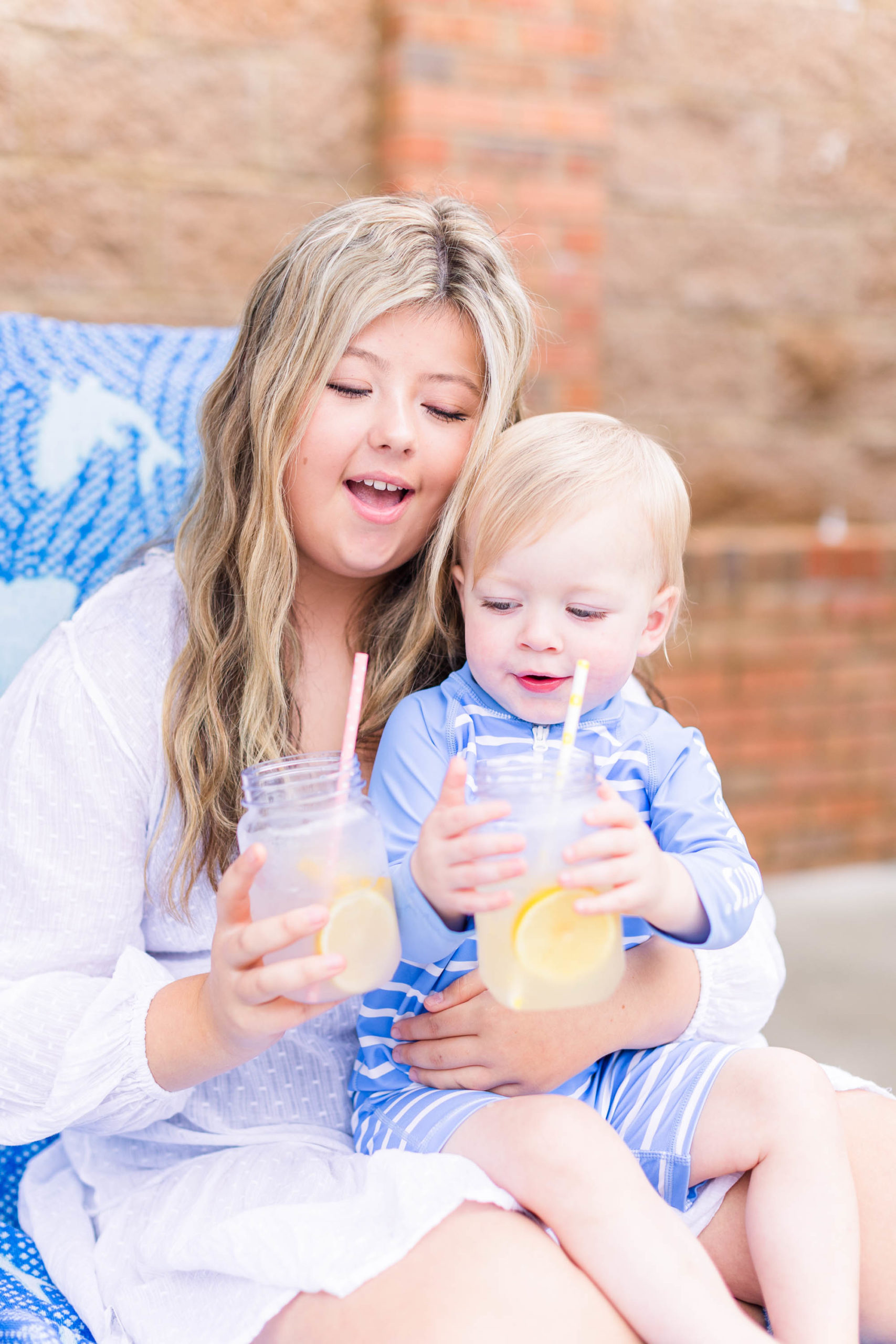 Happy kids drink lemonade at Pool Party Mini Sessions in Rossville, Georgia by local photographer Elle Bea Photography