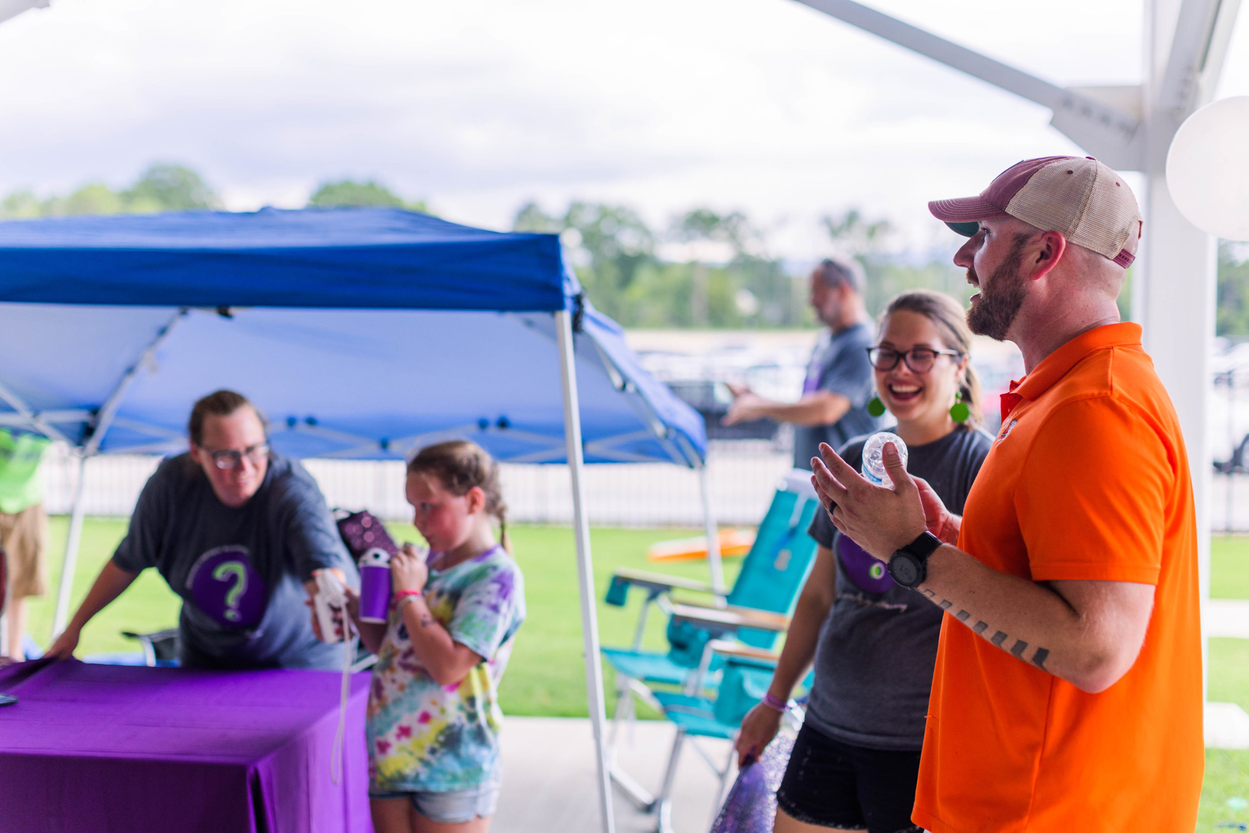 Mike Stiner, owner of Soccer Shots Chattanooga, chats with vendors at the Soccer Shots hosted Family Night 2022 at CHI Memorial Stadium, home of the Red Wolves