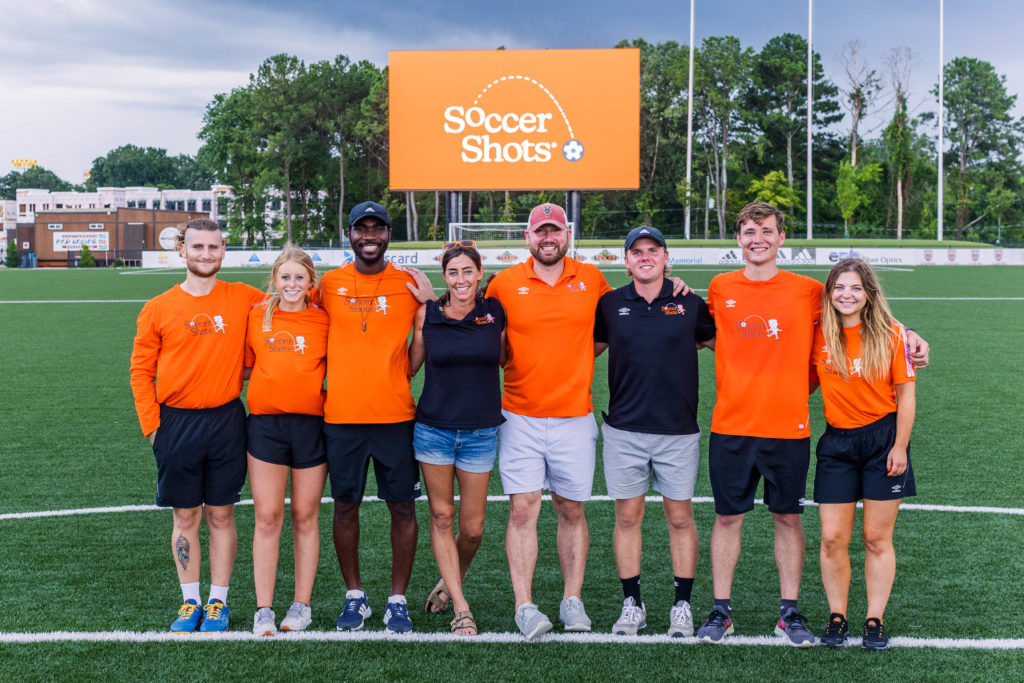 Soccer Shots Chattanooga staff poses for a photo after hosting Family Night 2022 at CHI Memorial Stadium, home of the Red Wolves