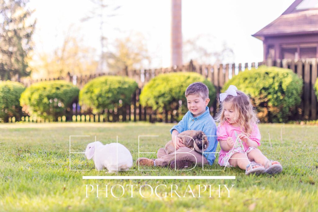 Brother and sister watch as white bunny escapes across the lawn at live bunny mini sessions in Chickamauga, Georgia