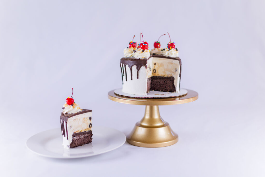 Hot Fudge Sundae ice cream cake cross section and slice on gold cake stand