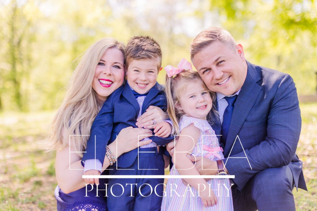 Beautiful blonde family, mom, dad, brother and sister, with flawless styling for family mini sessions, poses for a photo