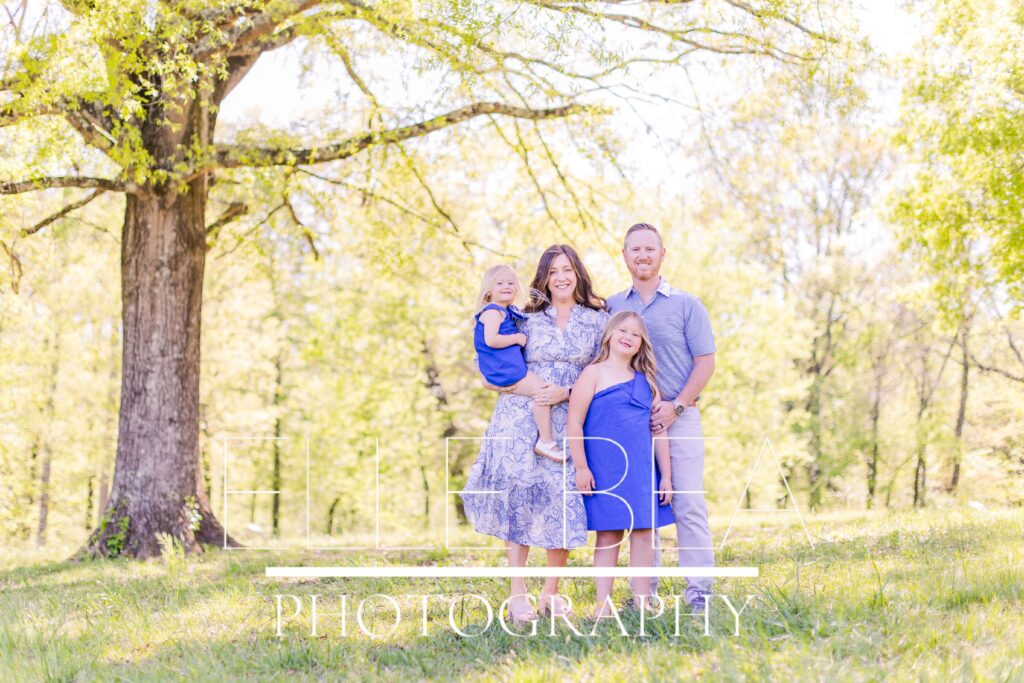 Family poses under a large tree in the Chickamauga Battlefield dressed in spring blues - clothing from Southern Charm Clothing in Ringgold, Georgia