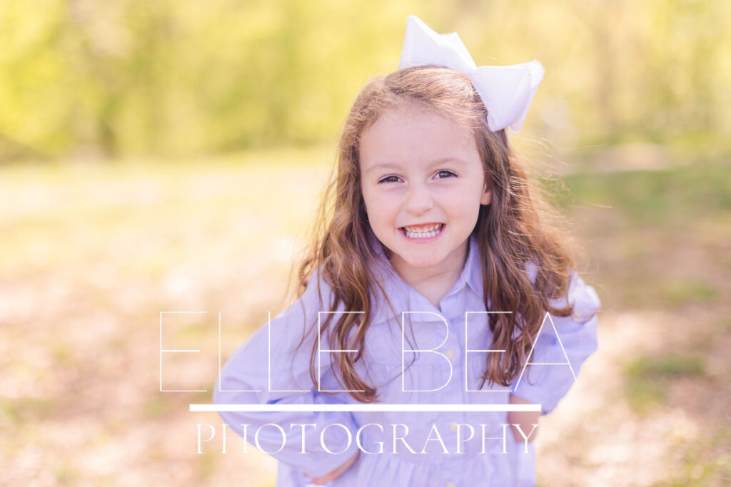 Little girl smiles and poses for a photo at Spring Family Mini Sessions in Chickamauga, Georgia