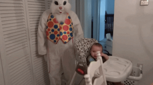 Girl screams at the scary Easter Bunny costume in her kitchen