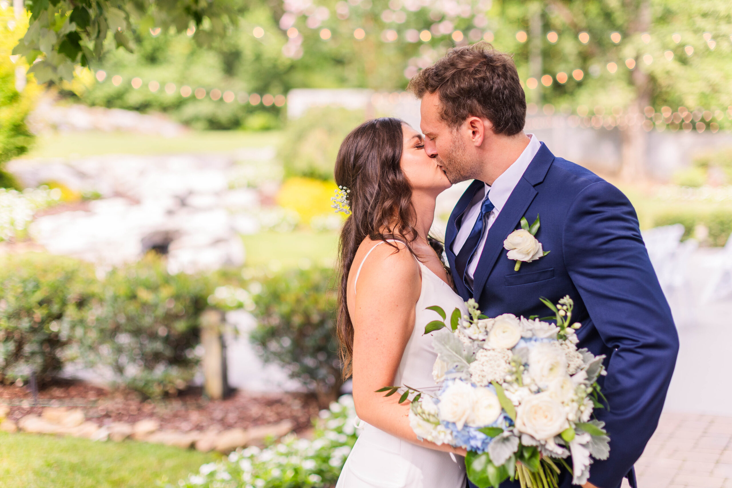 Emily + Ryan share a newlywed kiss after their wedding ceremony at The Venue Chattanooga on a beautiful July day in Tennessee.