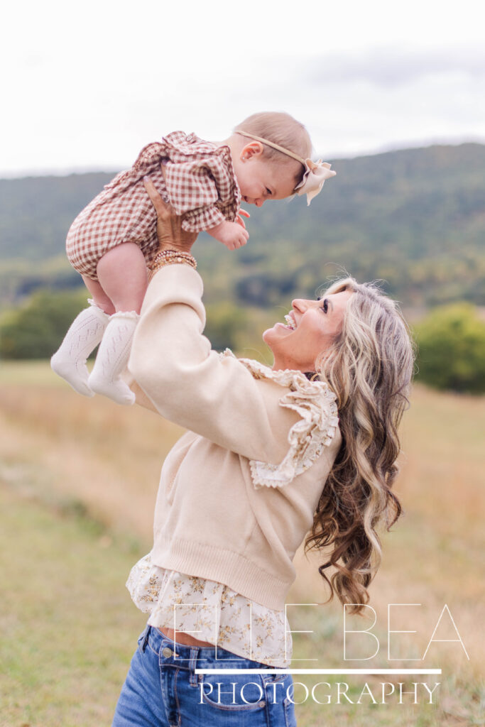 Grandmother holds baby girl during cloudy photoshoot in Chickamauga, Georgia