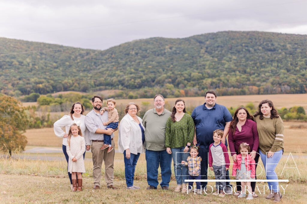 Extended family poses during a cloudy photoshoot at Mountain Cove Farms resort.