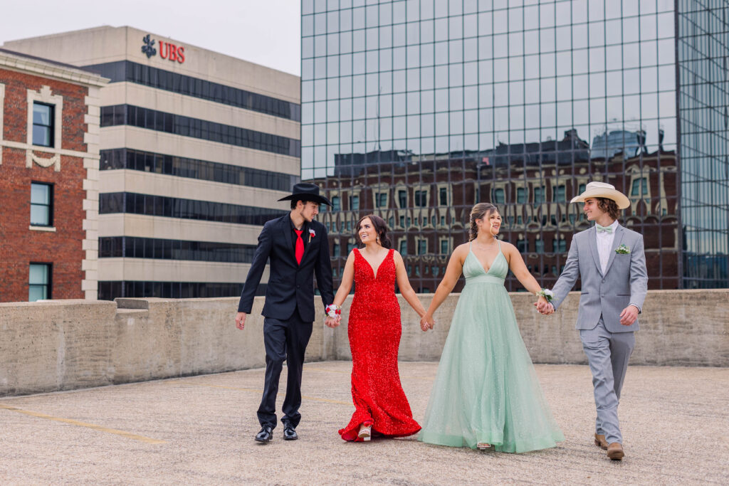 Two couples stroll together in rooftop prom photos in Chattanooga, Tennessee